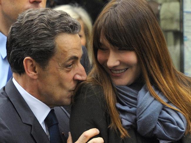 FILE - In this May 6, 2012 file photo, French President and UMP candidate Nicolas Sarkozy kisses his wife Carla Bruni-Sarkozy as they are greeted by supporters after casting their votes in the second round of French presidential elections in Paris. After Carla-Bruni Sarkozy, the top model turned songstress known for her free-wheeling lifestyle, here she is, Valerie Trierweiler. The intelligent, elegant twice-divorced journalist, with a perfume of scandal in her past, will become the first unwed partner of a French head of state to enter the Elysee Palace. (AP Photo/Philippe Wojazer, Pool, File)