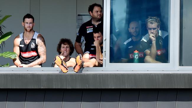 Jeremy Howe and Darcy Moore watch on as Collingwood players compete in an intra-club hitout. Picture: Nicole Garmston