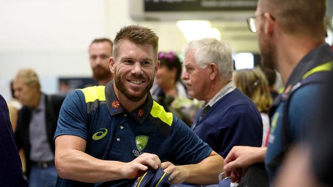 All smiles as David Warner arrives at Brisbane Airport for a pre-World Cup camp. Picture: Tara Croser.