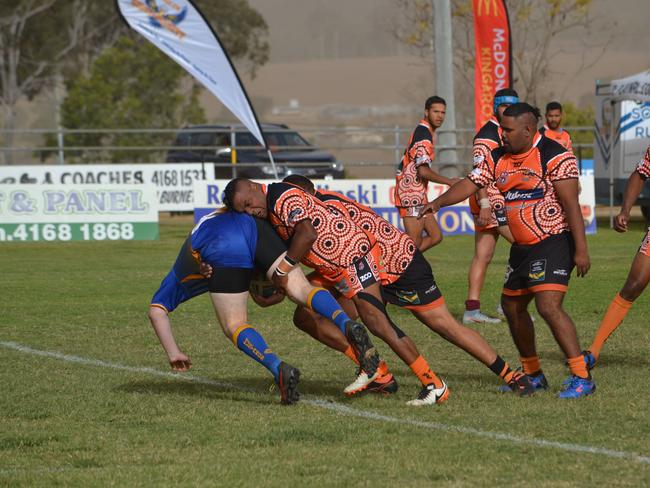 Cherbourg Hornet John Blair defending hard against the Murgon Mustangs. (Picture: file)