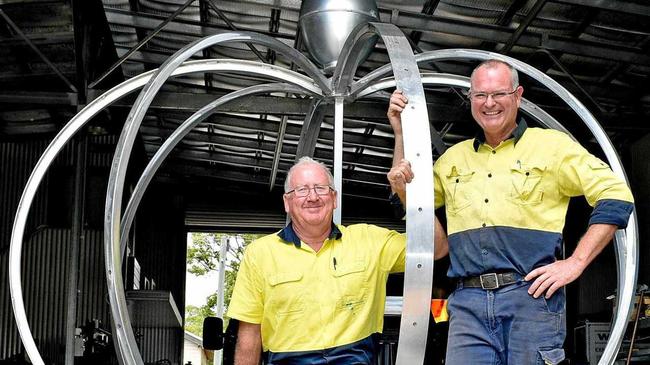 Electrician John Hough and Tony Blackadder from Grafton Ally Fabrications put the finishing touches to the new Jacaranda Queen Clocktower crown. Picture: Jenna Thompson