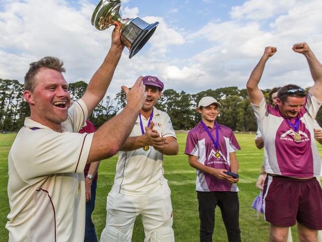 Red Hill captain-coach Simon Dart raises the premiership cup. Picture: Valeriu Campan