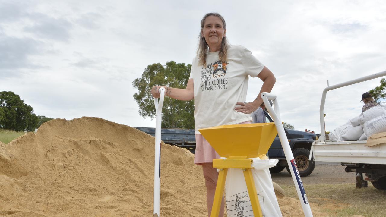 Karina Darlington filling sandbags at Grantham ahead of Cyclone Alfred.