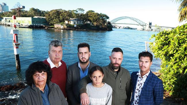 Ash Walker and his father Lloyd Walker with Beverly Simon (left) Michael Ingrey and daughter Nessa Foster and David Johnson (right) at Simmons Point Reserve in Balmain East with Goat Island behind them. Picture: John Feder