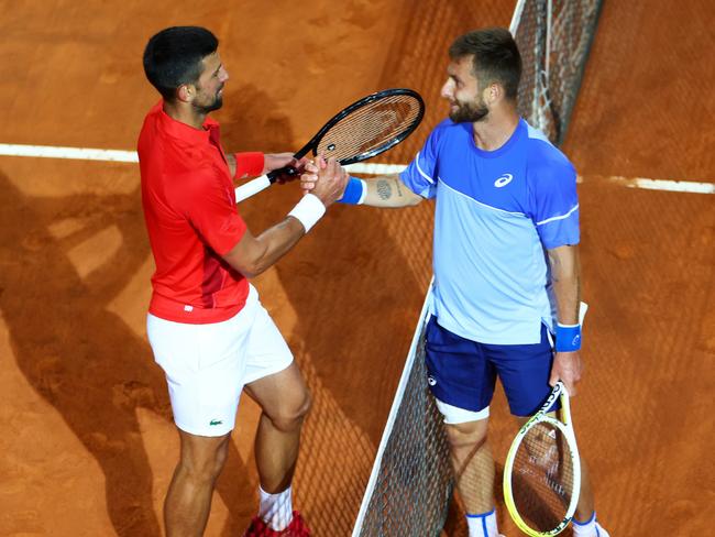 Djokovic and Moutet of France at the net moments before the former was struck. Picture: Dan Istitene/Getty Images