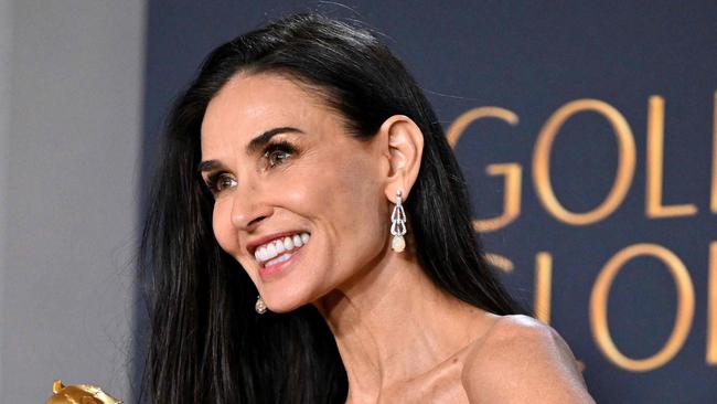 US actress Demi Moore poses with the Best Performance by a Female Actor in a Motion Picture â Musical or Comedy award for "The Substance" in the press room during the 82nd annual Golden Globe Awards at the Beverly Hilton hotel in Beverly Hills, California, on January 5, 2025. (Photo by Robyn Beck / AFP)