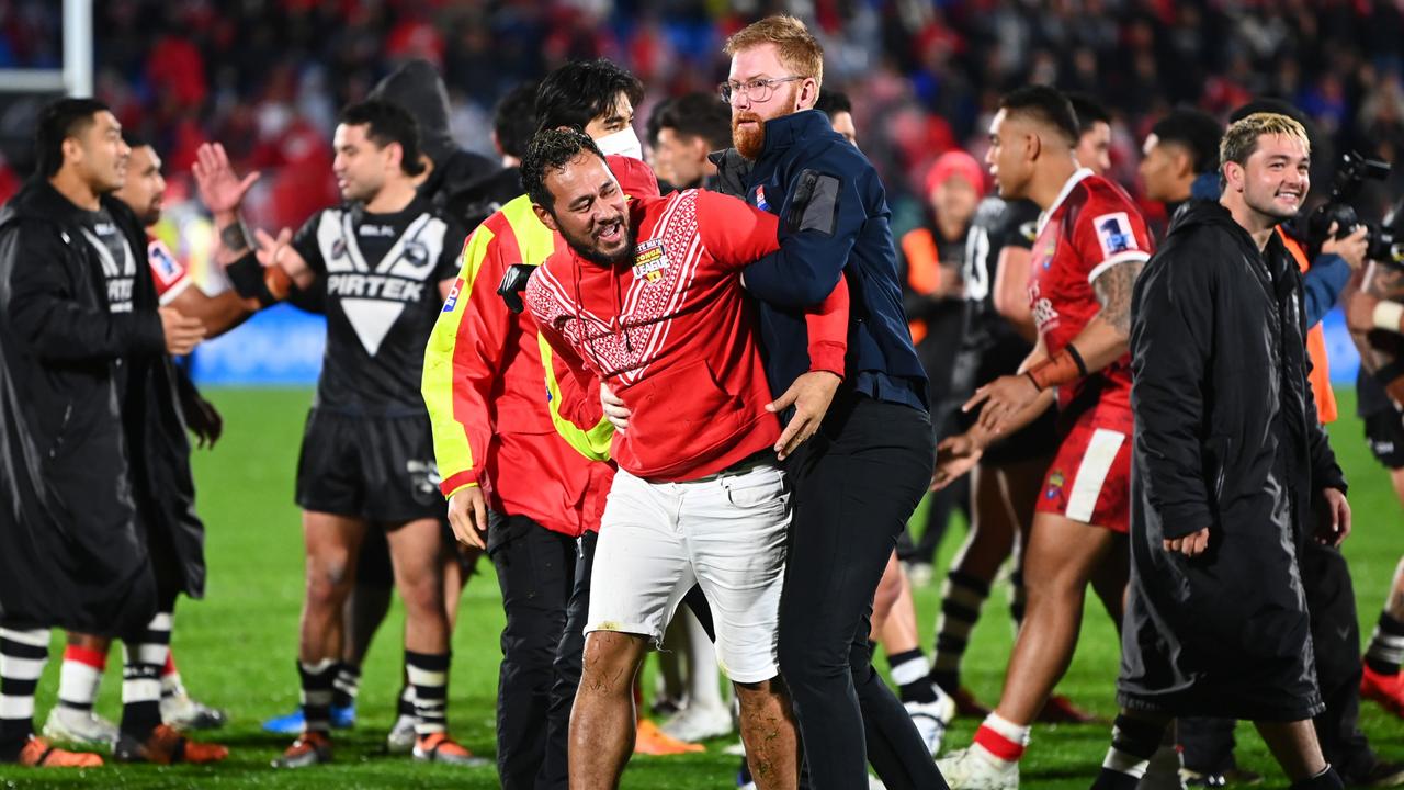 This pitch invader seemed to enjoy getting caught. (Photo by Hannah Peters/Getty Images)