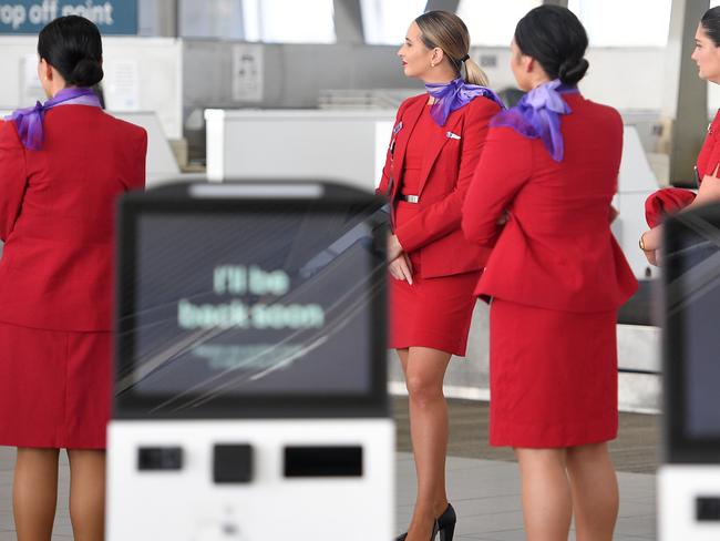 Virgin Australia employees are seen at Sydney Airport, in Sydney, Tuesday, April 21, 2020. Virgin confirmed it had gone into administration on Tuesday, threatening up to 10,000 airline jobs after a board meeting of its international shareholders voted on Monday against providing additional financial support. (AAP Image/Dan Himbrechts) NO ARCHIVING