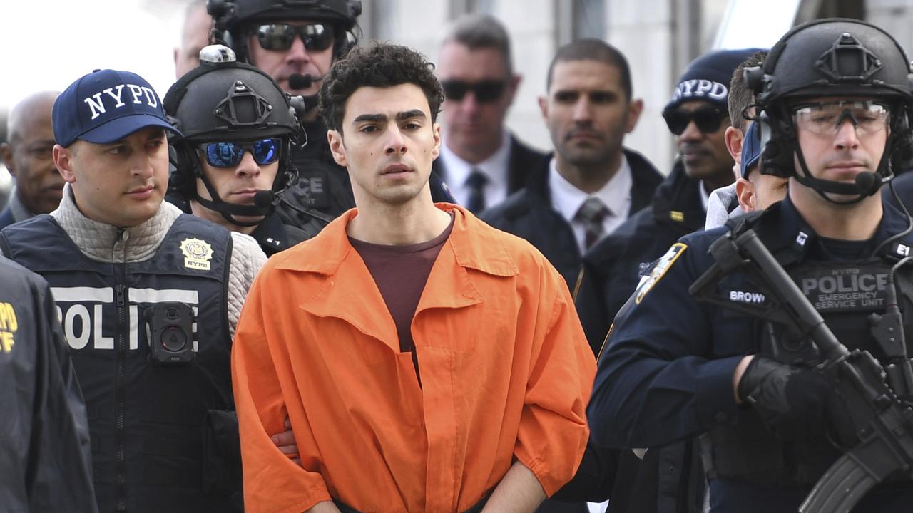 Luigi Mangione was surrounded by police as he arrived in New York. Picture: AP Photo/Pamela Smith