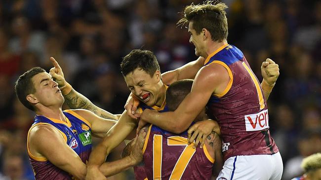 Lions players react after Hugh McCluggage (second from left) kicked a goal during the round 5 AFL match between the Western Bulldogs and the Brisbane Lions at Etihad Stadium in Melbourne, Saturday, April 22, 2017. (AAP Image/Julian Smith) NO ARCHIVING, EDITORIAL USE ONLY