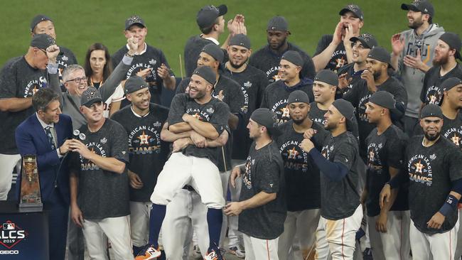 HOUSTON, TX - OCTOBER 19: Jose Altuve #27 of the Houston Astros is lifted in celebration during the trophy presentation after Game Six of the League Championship Series against the New York Yankees at Minute Maid Park on October 19, 2019 in Houston, Texas. (Photo by Tim Warner/Getty Images)