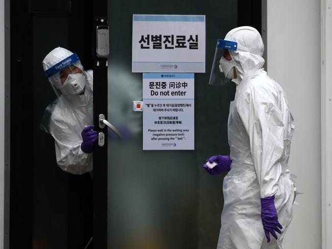 A disinfection professional wears protective gear spray antiseptic solution against the coronavirus in Seoul, South Korea. Picture: Getty Images