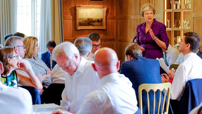 David Davis, centre, and other members of her cabinet listen to Prime Minister Theresa May at Chequers last Friday. Picture: AFP.