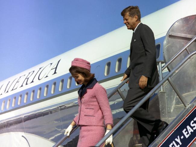 John F. Kennedy and wife Jackie descend the stairs from Air Force One at Love Field in Dallas, Texas, an hour before his assassination.