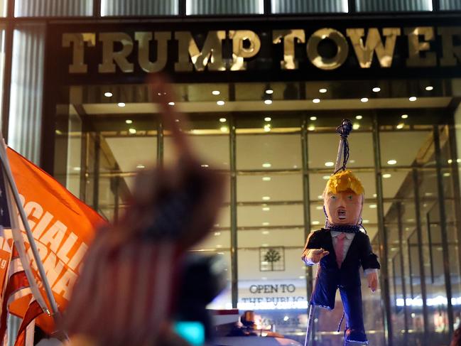 Protestors hoist an effigy of Donald Trump outside of Trump Tower, November 9, 2016 in New York City. Picture: AFP