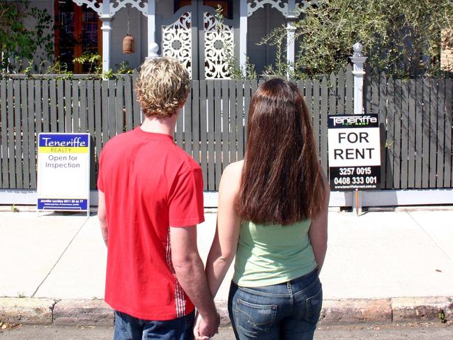 Couple outside houses for sale and for rent 30 Aug 2004. Real Estate Signs.