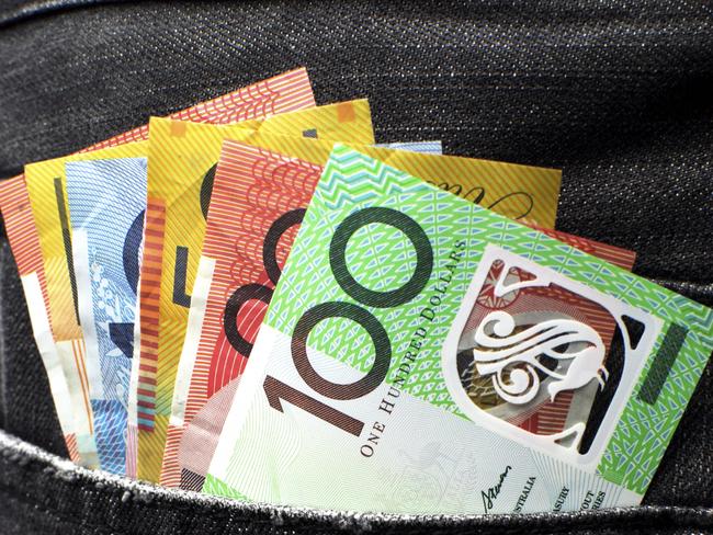 Budget2016 - stock images to be used for Budget 2016 stories. Australian money including 100, 50, 5, 10 and 20 dollar notes, in back pocket of a man's black charcoal jeans pocket. Vertical. Picture: istock
