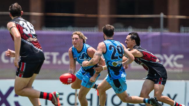 Baxter Mensch looks to handball against the Tiwi Bombers in Round 4 of the 2024-25 NTFL season. Picture: Pema Tamang Pakhrin