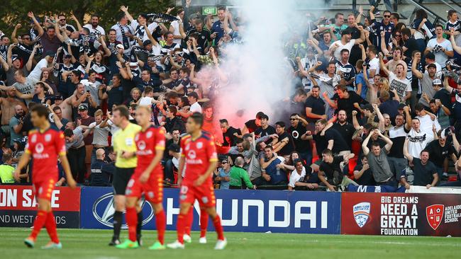 Adelaide United v Melbourne Victory at Coopers Stadium. Victory fans celebrate goal with a flare. Photo Sarah Reed.