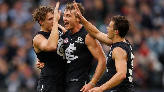 Patrick Cripps celebrates Carlton’s win with Charlie and Ed Curnow.