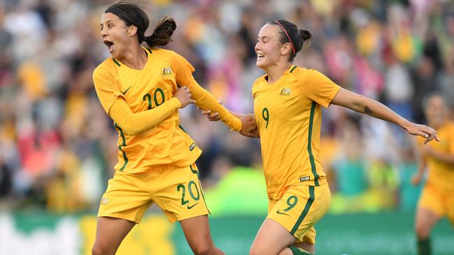 Sam Kerr (left) celebrates with Caitlin Foord. (AAP Image/Dean Lewins)