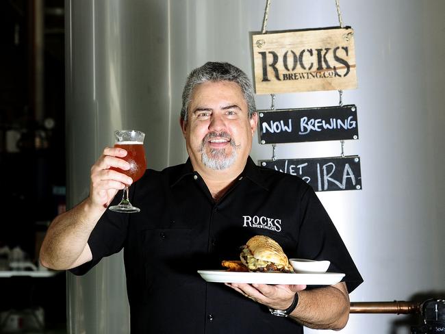 Simon Osbourne in front of the vats at the Rocks Brewing Co in Alexandria. Picture: John Appleyard