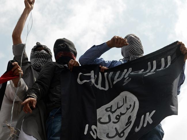 Kashmiri demonstrators hold up a flag of the Islamic State. AFP PHOTO/Tauseef MUSTAFA/FILES