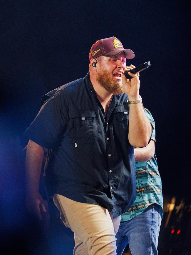 Luke Combs wearing a Brisbane Broncos hat while performing at Suncorp Stadium