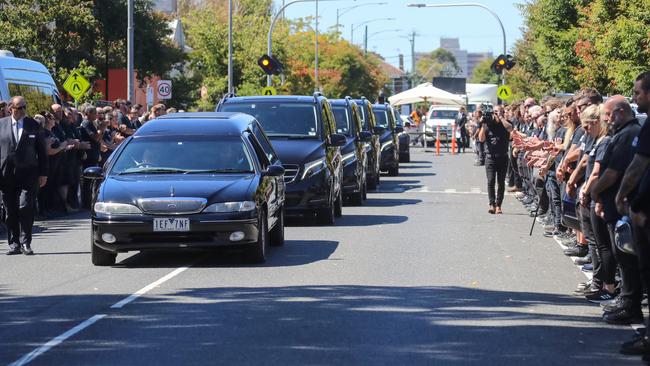 At the funeral of Michael Gudinski, more than 160 music industry workers formed a guard of honour outside Ormond Hall in Melbourne, with ‘MG CREW FOREVER’ emblazoned on their black T-shirts. Picture: Alex Coppel