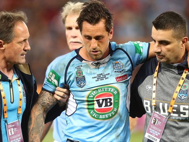 Mitchell Pearce is helped from the field.