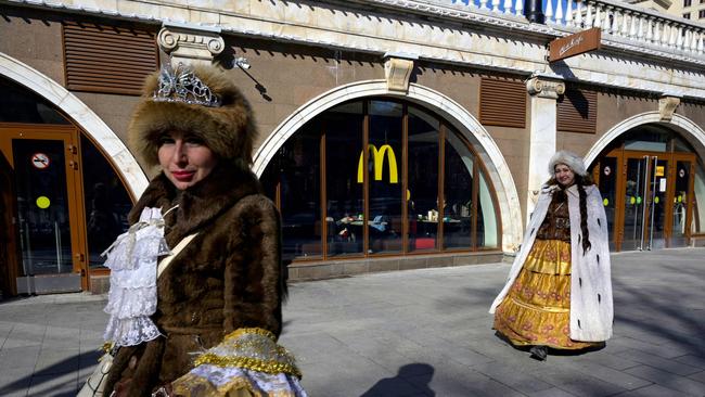 Women walk in front of a McDonald's restaurant in central Moscow on March 9. McDonald's, Coca-Cola and Starbucks on March 8 bowed to public pressure and suspended their operations in Russia, joining the international corporate chorus of outrage over Moscow's invasion of Ukraine. Picture: AFP