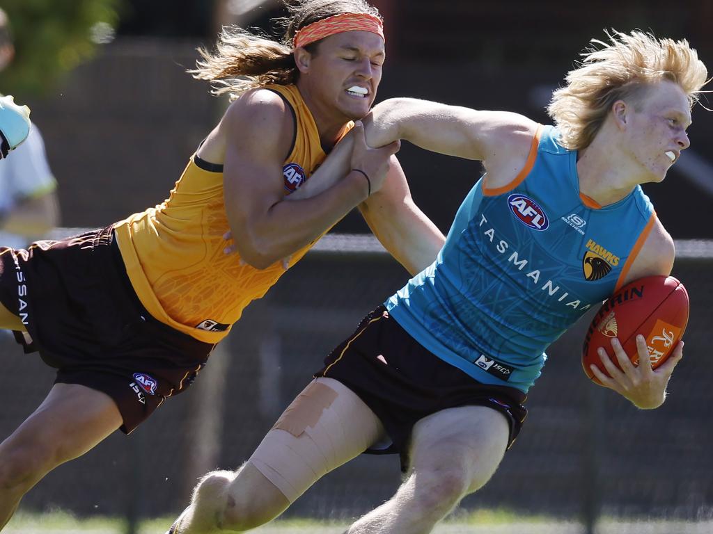 Bodie Ryan tries to slip through a Jack Ginnivan tackle at training. Picture: Michael Klein