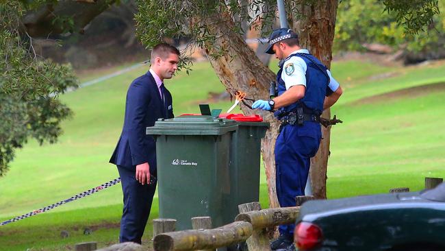 Officer retrieves a pair of scissors from the garbage bin in the carpark area. Unknown if the scissors are connected to the crime. Police are conducting an investigation following the death of a female in SydneyÕs inner west overnight. Shortly before 11.30pm yesterday, (Thursday 7 April 2016), emergency services were called to Cabarita Wharf, Cabarita following reports of woman being assaulted. Officers attached to Burwood Local Area Command attended and upon arrival located a womanÕs body in the water. The woman, believed to be aged in her 20Õs, was treated at the scene by police and NSW Ambulance Paramedics, but was unable to be revived. A man has been taken to Burwood Police Station where he is assisting police with inquires. Police have established a crime scene which will be examined by forensic specialists. Detectives from Burwood Local Area Command are investigating the incident.