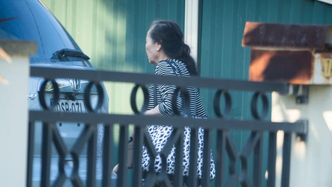 A loved one of Thi Kim Tran, who was kidnapped and put in the back of a car before her body was found, arrive at her home in Bankstown. Picture: Tom Parrish