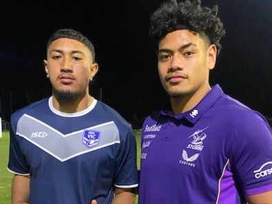 Under-15 Victorian player Carlos Faaofo-Taula receives his shirt from Melbourne Storm player Jerry Musu. Picture: Hamish Pearce.