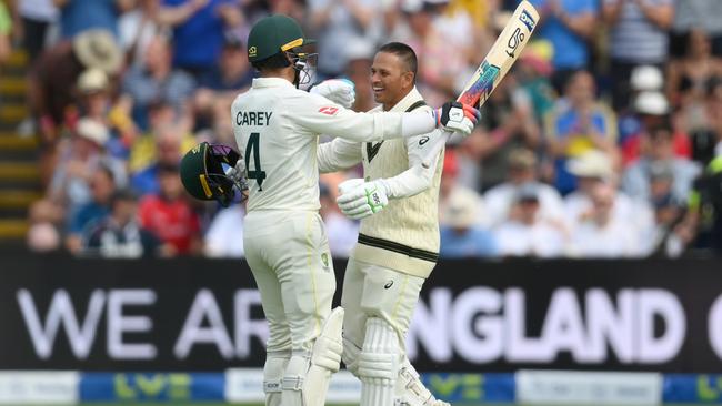 Usman Khawaja celebrates his century with Alex Carey. (Photo by Shaun Botterill/Getty Images)