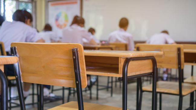 Lecture room or School empty classroom with Student taking exams, writing examination for studying lessons in high school thailand, interior of secondary education, whiteboard. educational concept. Source: iStock Credit:smolaw11