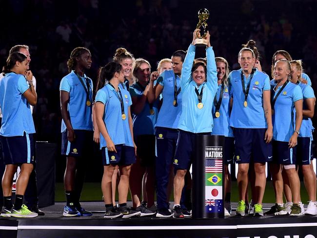 Matildas forward Lisa De Vanna lifts the Tournament of Nations trophy.