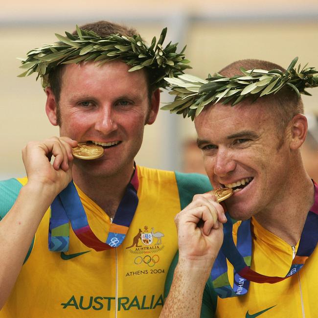 Graeme Brown, left, and Stuart O'Grady of Australia receive their gold medals for winning the men's track cycling Madison event at the Athens Olympics in 200. Picture: Ian Waldie/Getty Images