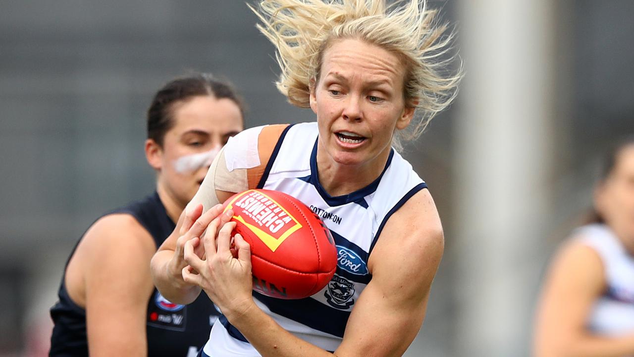 Cats forward Phoebe McWilliams marks strongly.