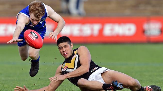 St Peters Ben Mcgill dives for the ball in front of Brighton's Luke Bonfiglio on Saturday. Picture: Tom Huntley