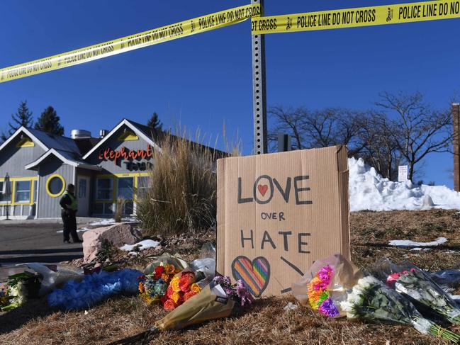 Bouquets of flowers and a sign reading "Love Over Hate" are left near Club Q, an LGBTQ nightclub in Colorado Springs. Picture: AFP.