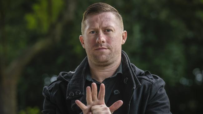 Imran Webb, who is an Auslan interpreter seen regularly on tv during the coronavirus crisis, demonstrates the Corona Virus sign. Picture: Roy VanDerVegt