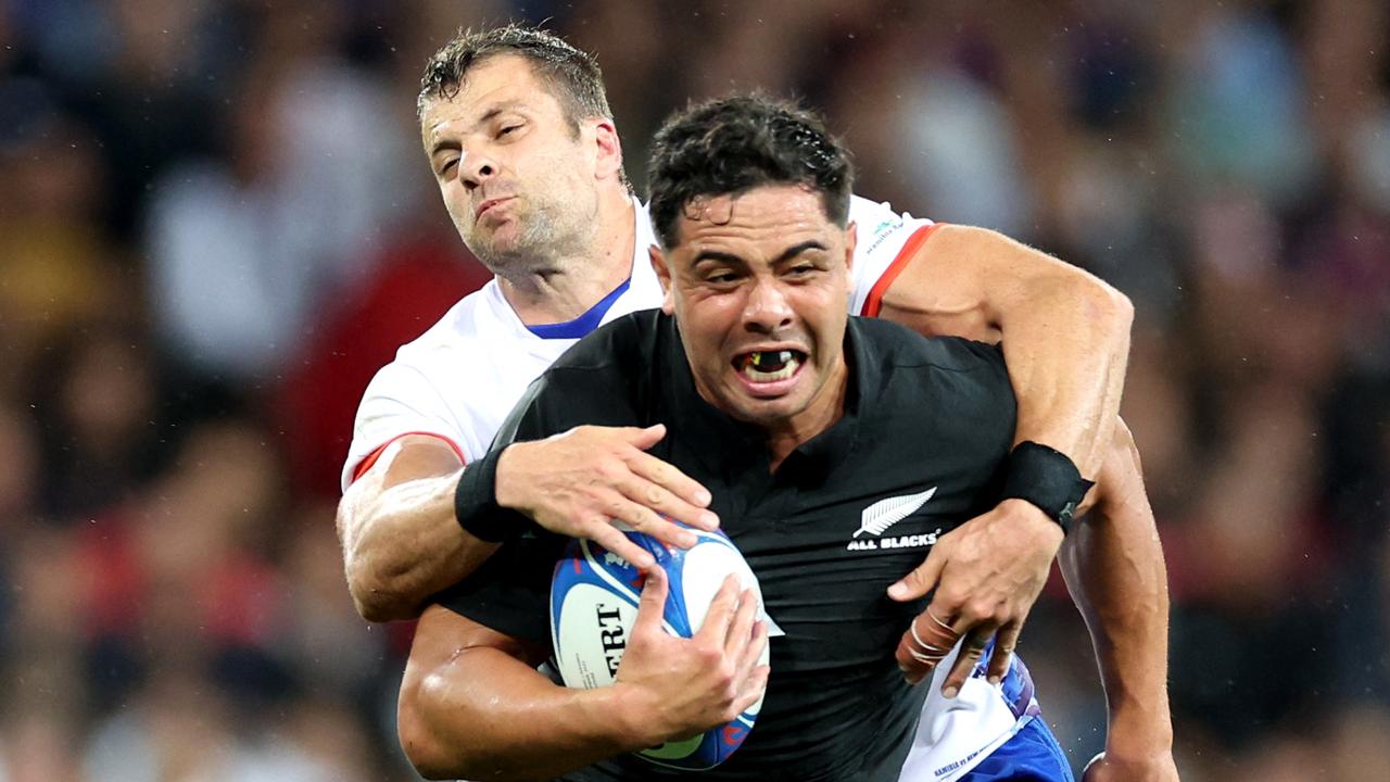 New Zealand's outside centre Anton Lienert-Brown (C) is tackled by Namibia's centre Johan Corne Greyling during the France 2023 Rugby World Cup Pool A match between New Zealand and Namibia at Stadium de Toulouse in Toulouse, southwestern France on September 15, 2023. (Photo by CHARLY TRIBALLEAU / AFP)