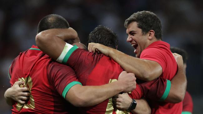 Portugal's flanker Manuel Picao (right) celebrates with teammates after his side’s win over Fiji. Picture: AFP