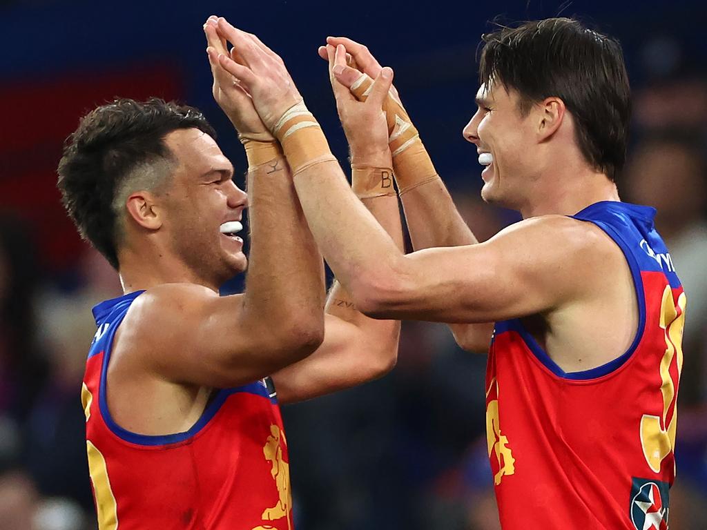 Eric Hipwood (right) of the Lions is congratulated by Cam Rayner after kicking a goal. (Photo by Quinn Rooney/Getty Images)