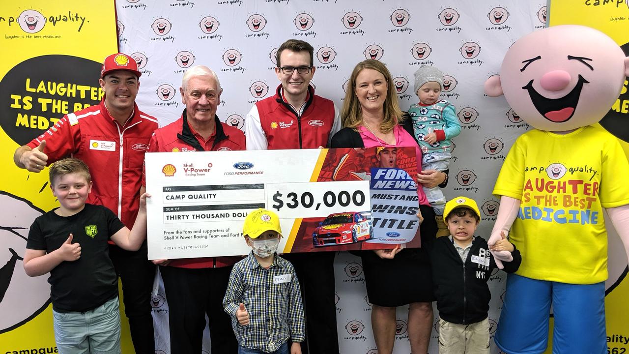 McLaughlin, Johnson and Story hand the cheque to Camp Quality.