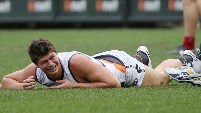 Jon Patton lies on the turf after hurting his knee. Picture: Colleen Petch