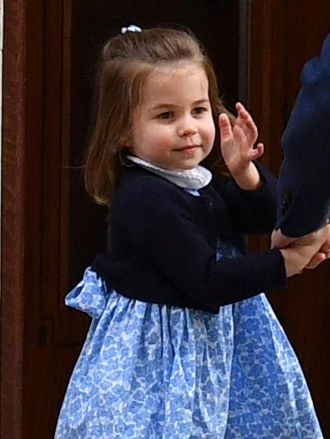 Princess Charlotte waves to reporters after her brother’s birth in April. Picture: AFP