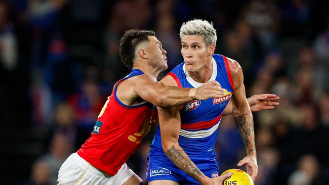 MELBOURNE, AUSTRALIA – JUNE 07: Rory Lobb of the Bulldogs is tackled by Cam Rayner of the Lions during the 2024 AFL Round 13 match between the Western Bulldogs and the Brisbane Lions at Marvel Stadium on June 07, 2024 in Melbourne, Australia. (Photo by Dylan Burns/AFL Photos via Getty Images)